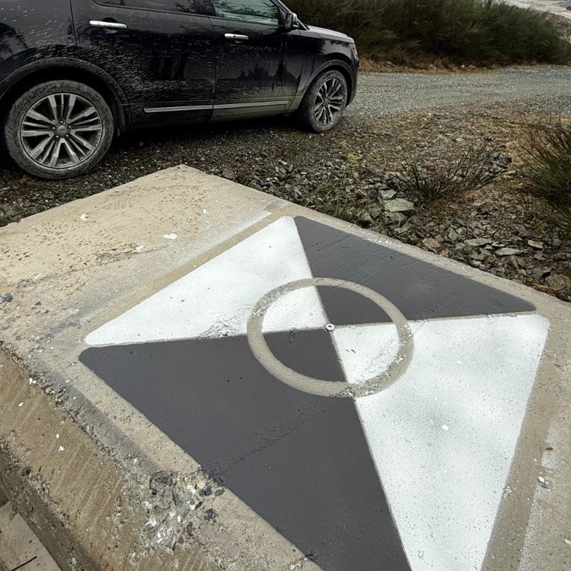 A painted survey control monument at a Vancouver Island site, used to check survey accuracy