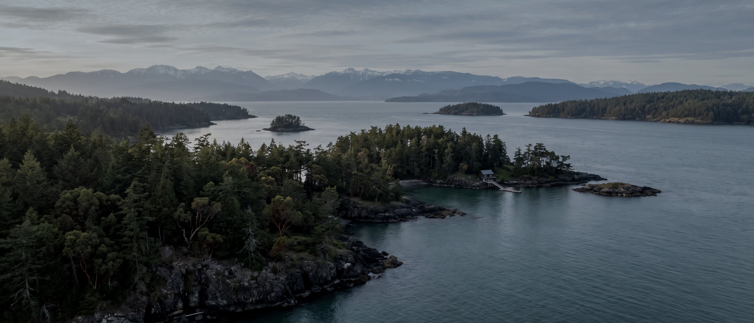 Aerial view of forested islands and a calm channel off Vancouver Island